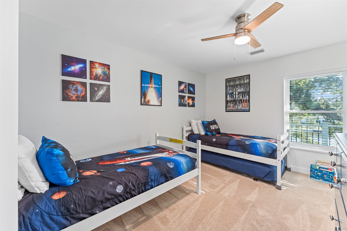 The Moon Room with a NASA space theme has 2 twin beds and an additional twin trundle bed