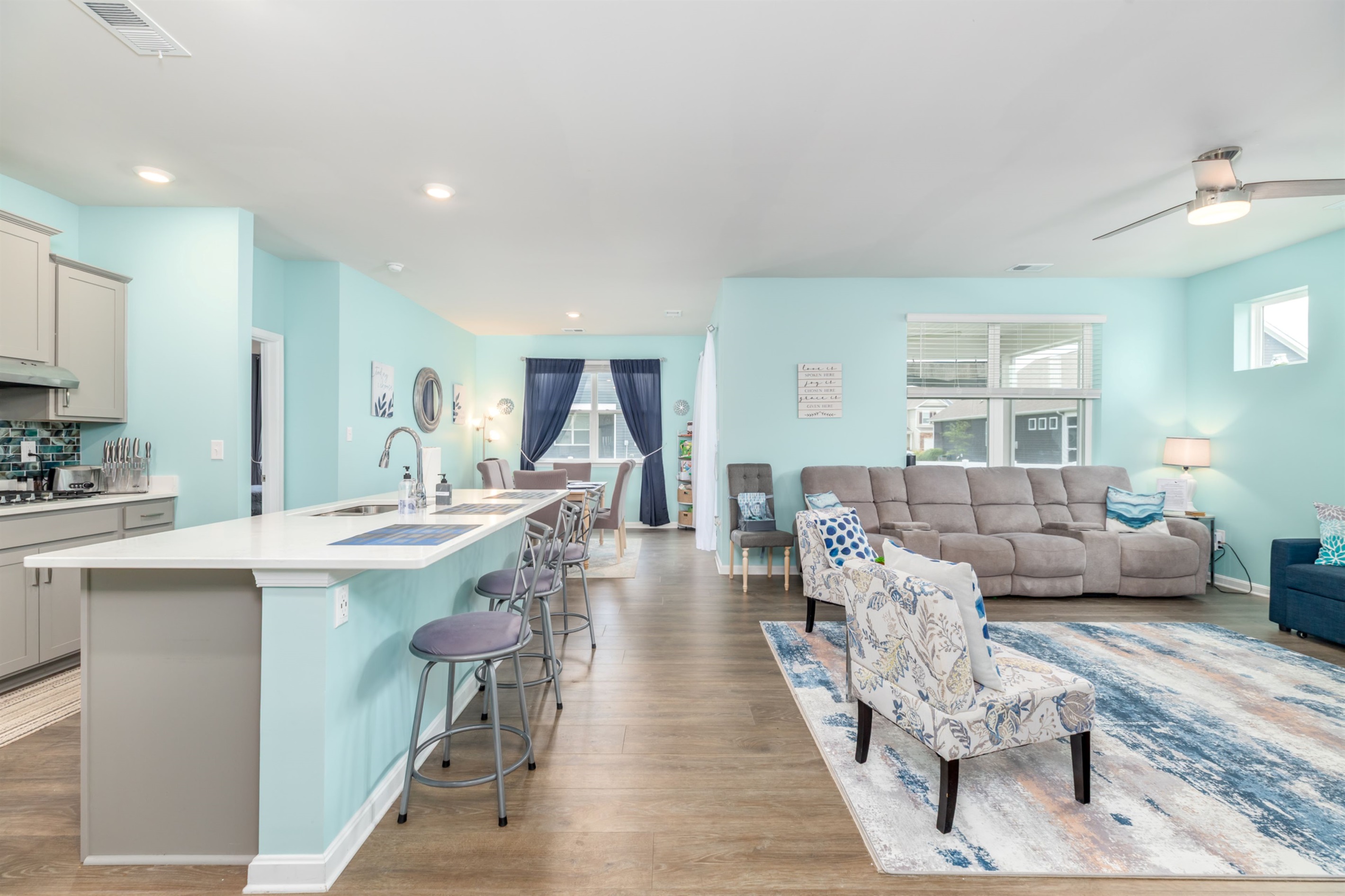 Bright, open-concept living space featuring a spacious breakfast bar, gourmet kitchen, and cozy seating—perfect for family meals, entertaining friends, or relaxing after a day at the beach.