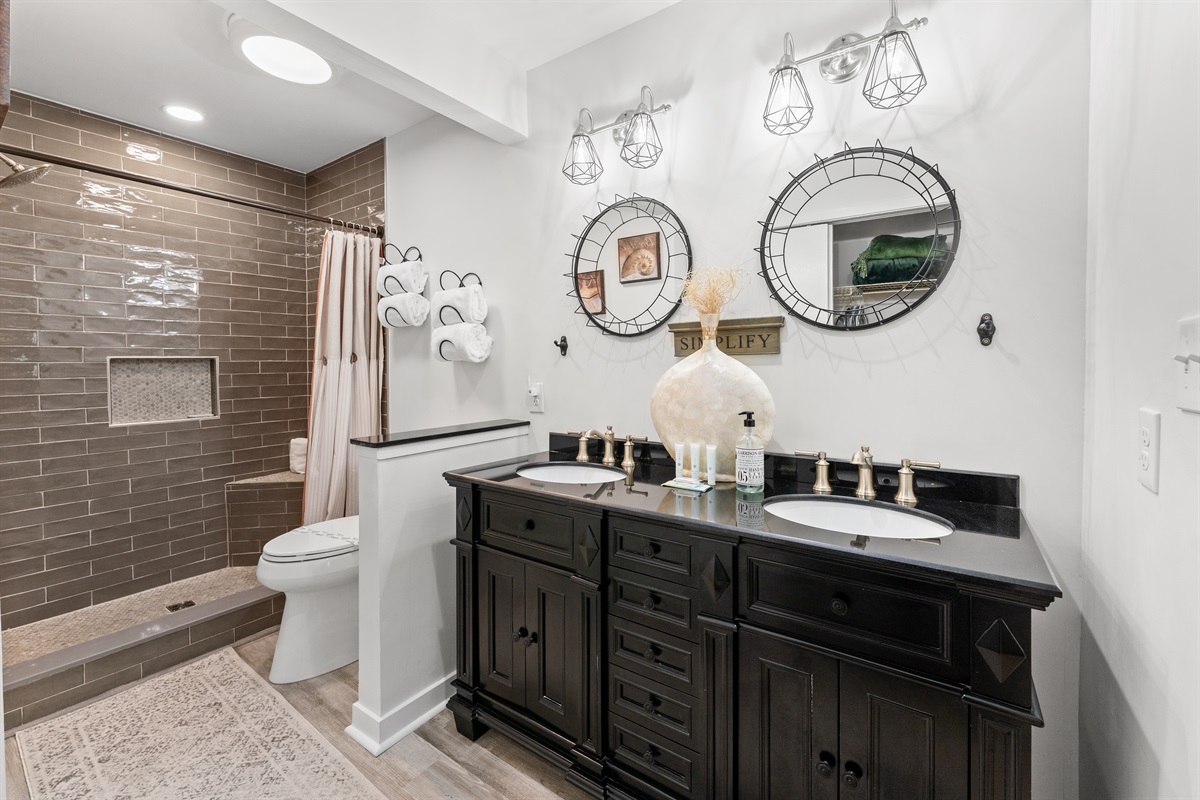 Main bathroom with double vanity and stand alone shower