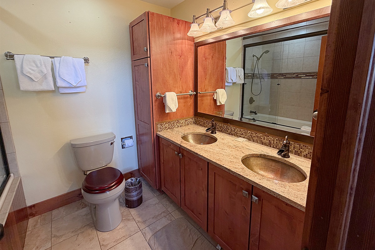 Primary attached full bathroom with dual vanity sinks.