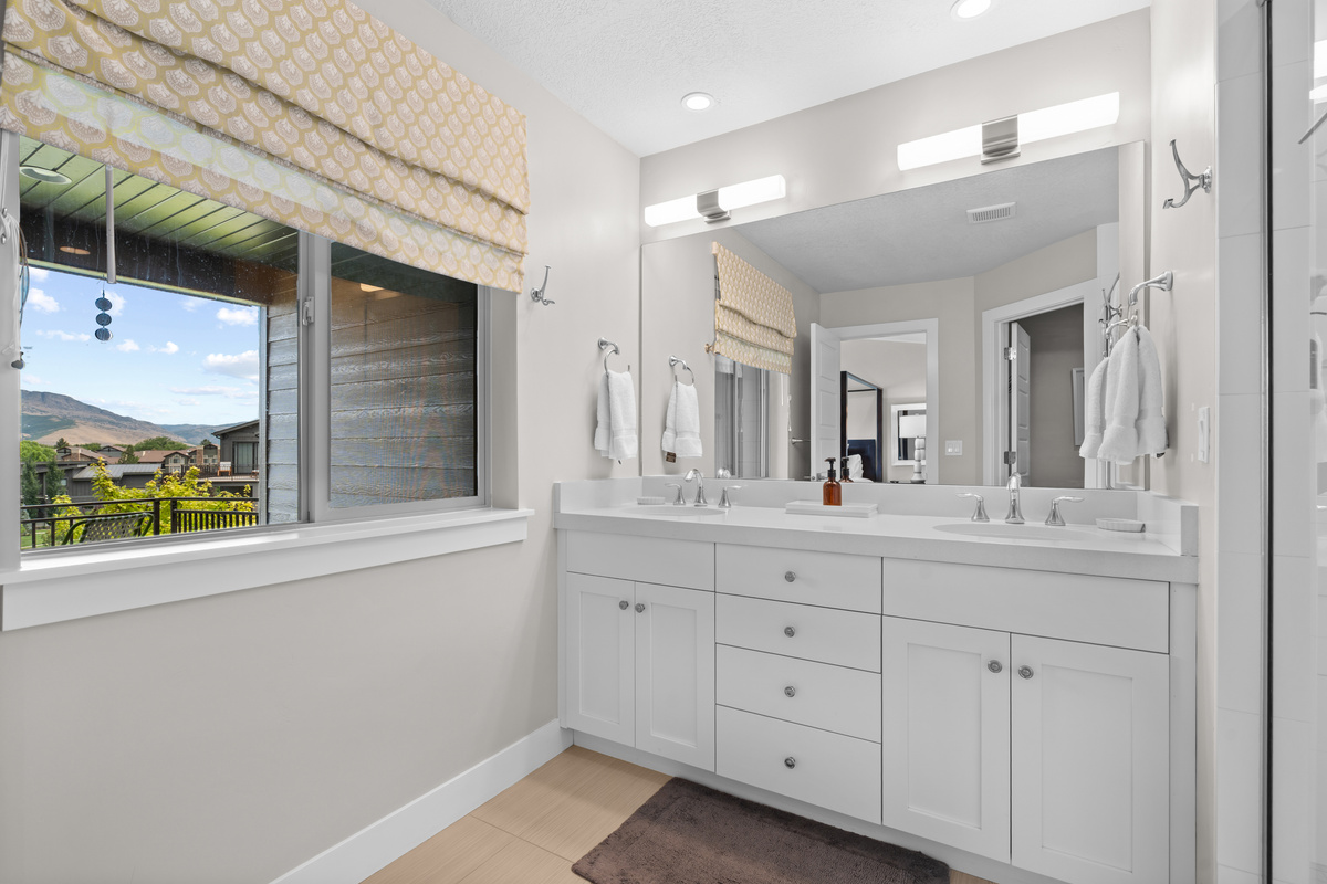 Enjoy a spacious primary bath with mountain views and modern finishes.