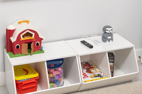 Entertainment corner with wall-mounted TV and toy storage below.

