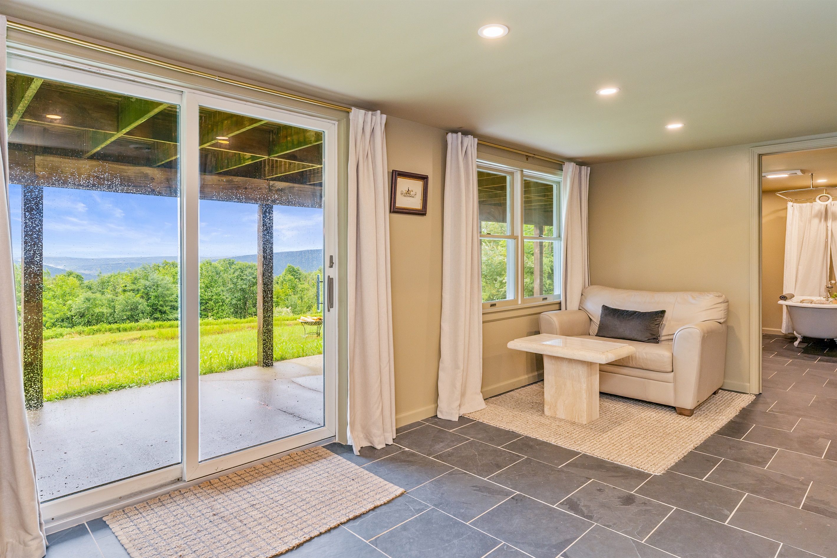 Wake up to stunning views from this walkout lower level bedroom suite with private sitting area and patio access.