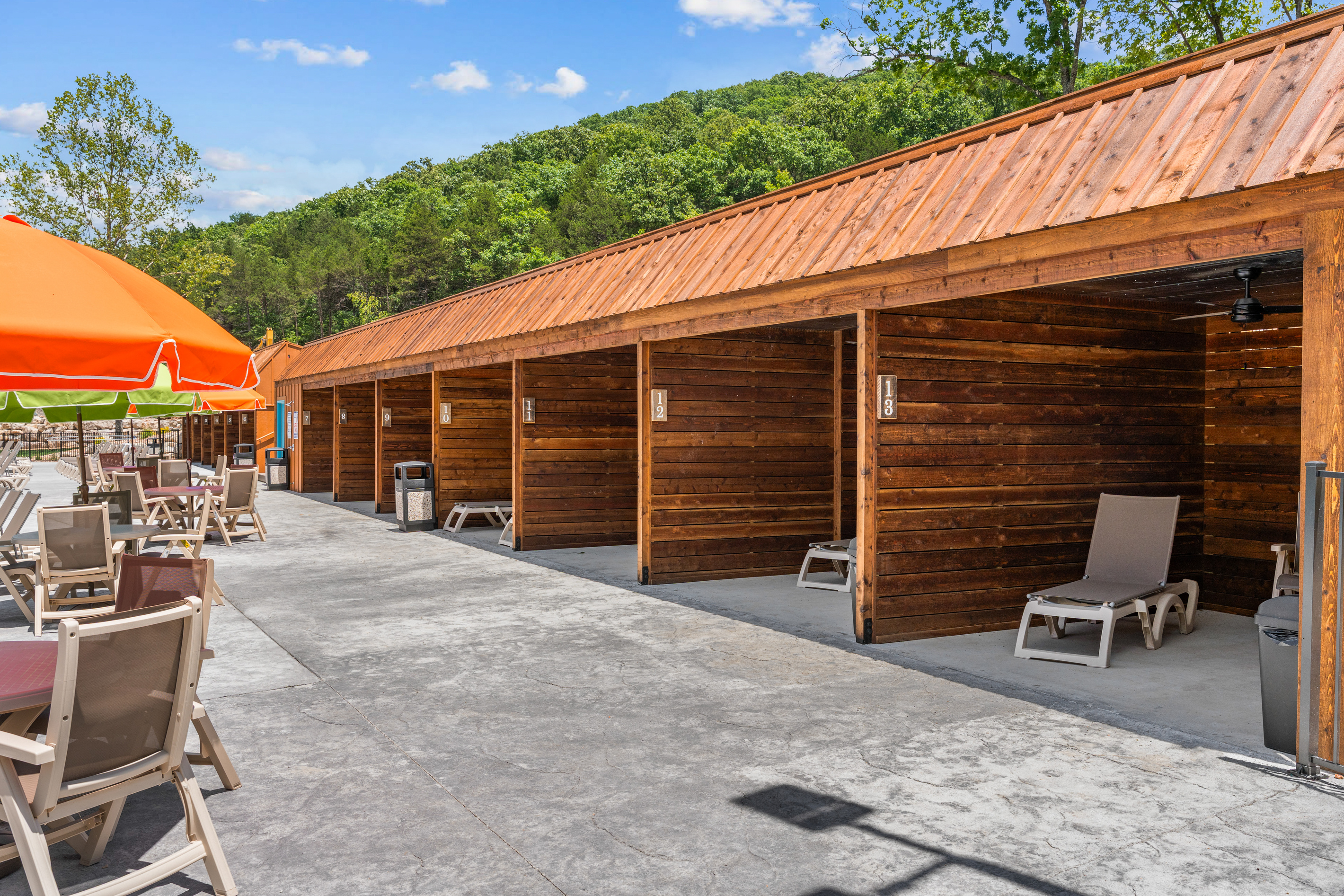 Settle in under a bright cabana umbrella ,  poolside seating made for slow, sunny afternoons.