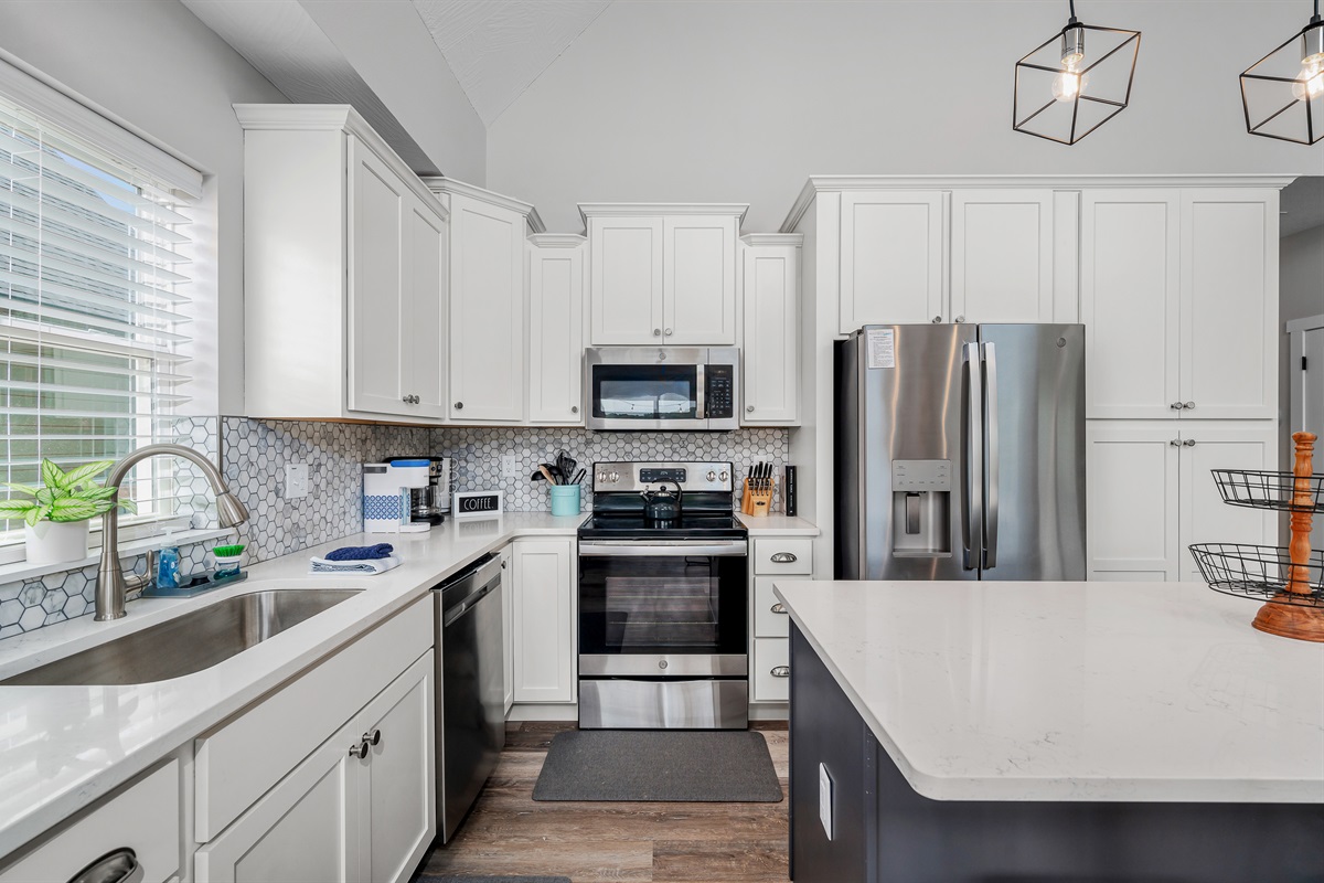 Clean white cabinetry perfectly offsets the stainless appliances and granite counters