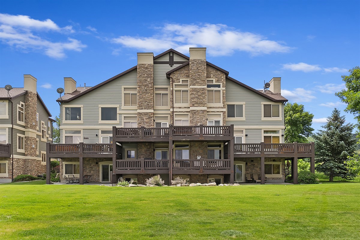 Rear view of the property showcasing multiple decks and outdoor spaces.