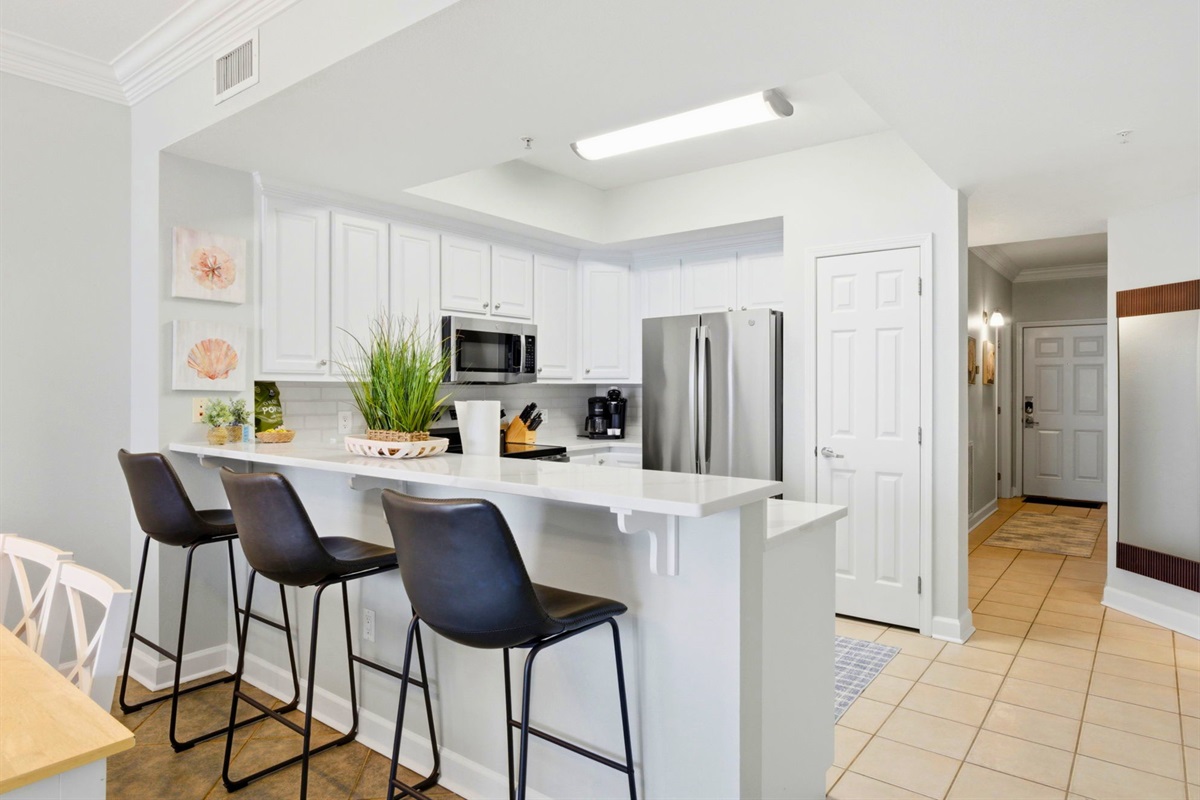 The breakfast bar provides additional seating, making it the perfect spot for a quick snack or morning coffee.