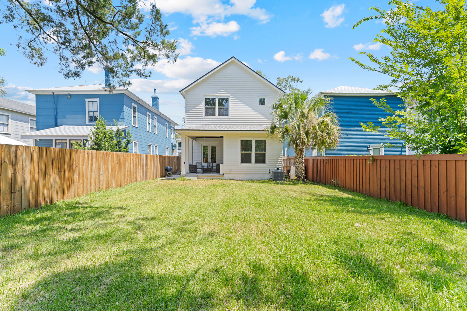 Room to run, right in the heart of the city. Kids chase each other across the grass while burgers sizzle on the grill and the grown-ups claim the shaded patio. Fenced, private, made for long Florida evenings.