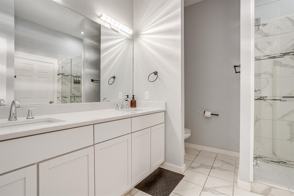 Bright bathroom with essentials provided—easy refresh before a night out.