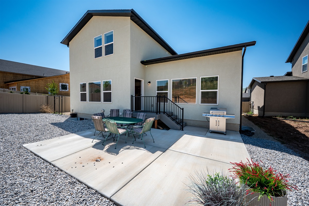 The patio offers the ideal space to gather, featuring seating for eight and a gas grill for easy outdoor meals and entertaining.