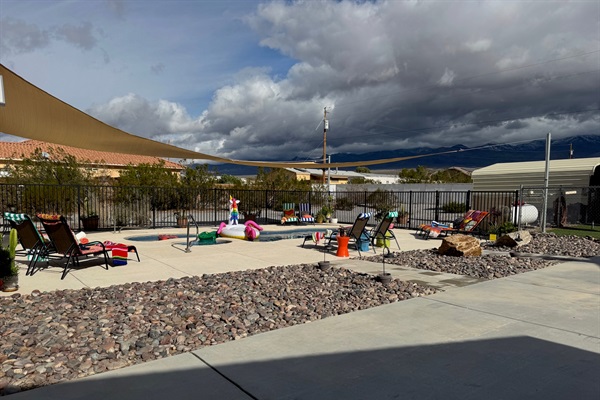 Pool loungers & massive patio space for relaxing in the desert sun.