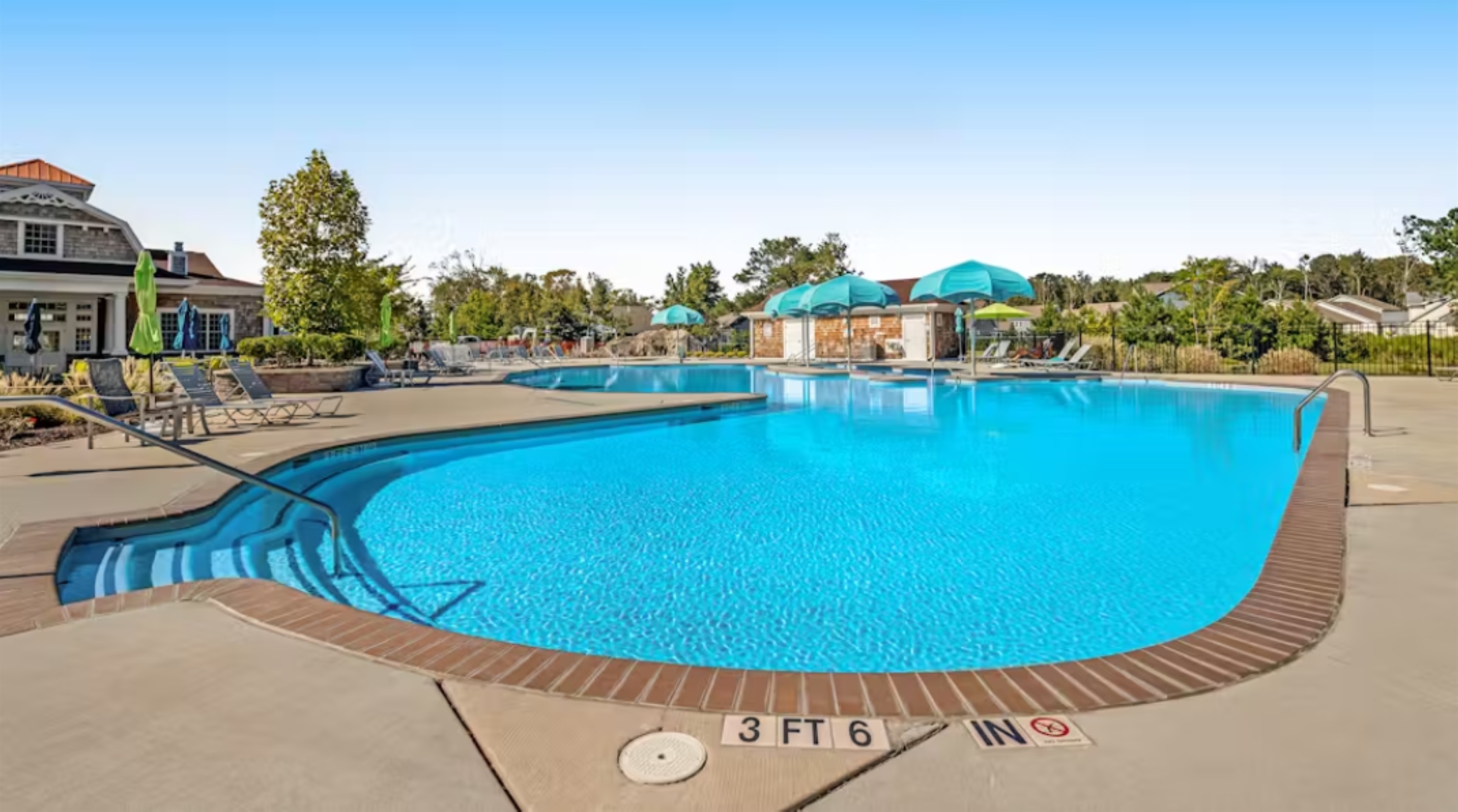 Main pool depth markers visible, showing a gradual slope from 3 to 6 feet—ideal for swimmers of all abilities.