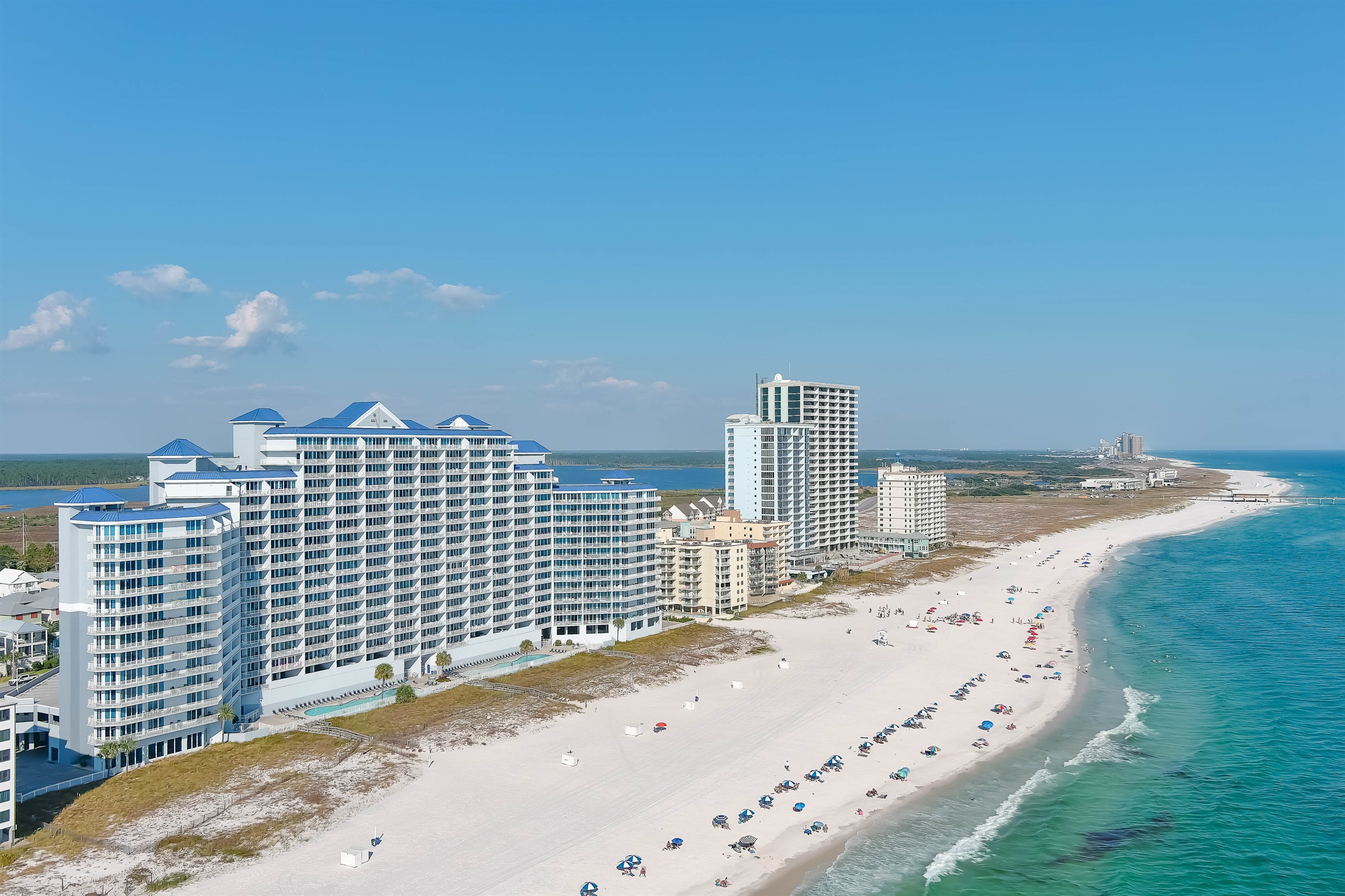 Step from your door to the shore. Enjoy private beach access and emerald waters at this top-rated Gulf Shores vacation rental.