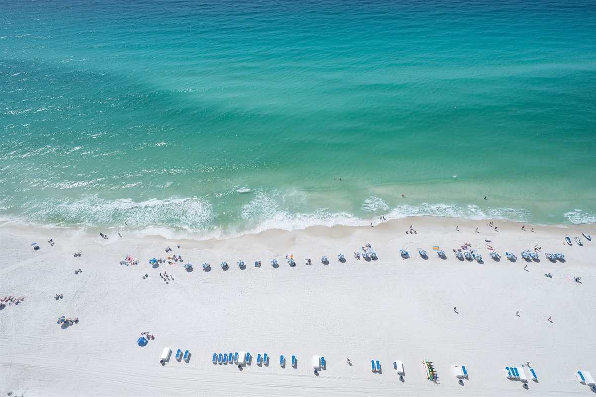 Balcony views of white sand and emerald water