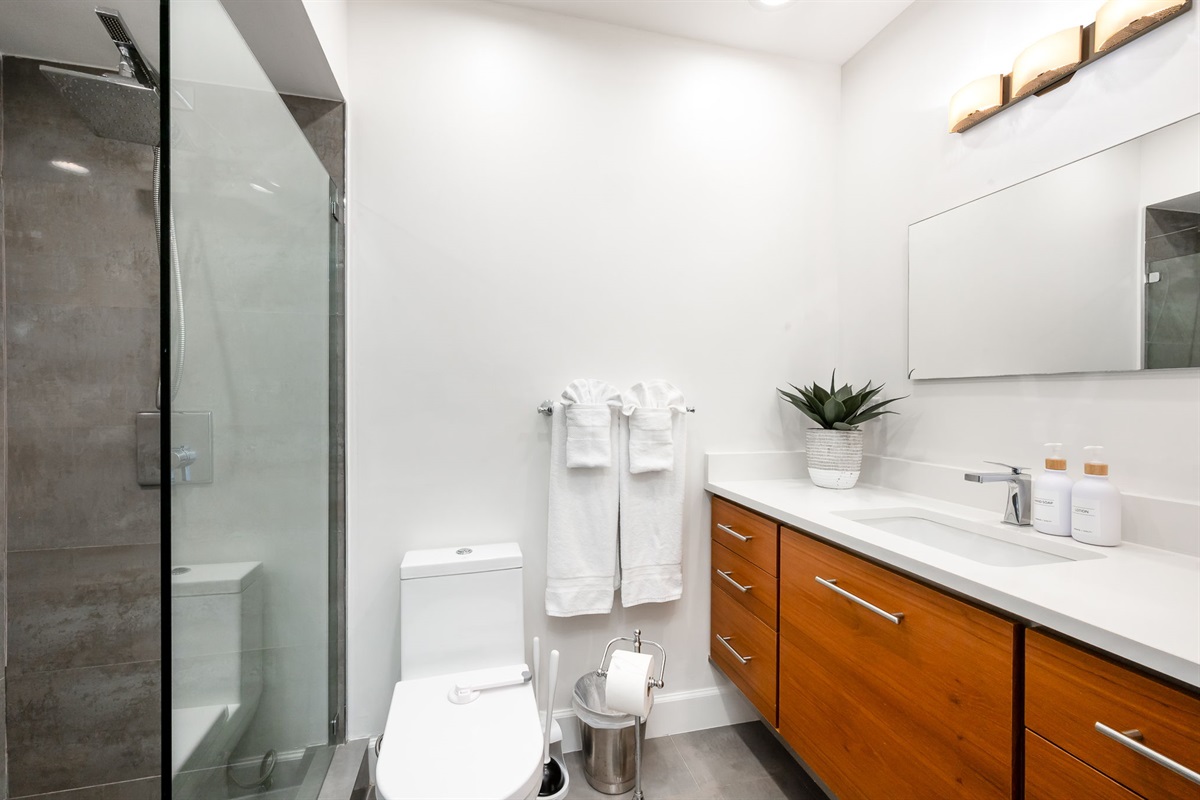 Start your day refreshed in the spacious walk-in shower, designed with both style and comfort in mind.