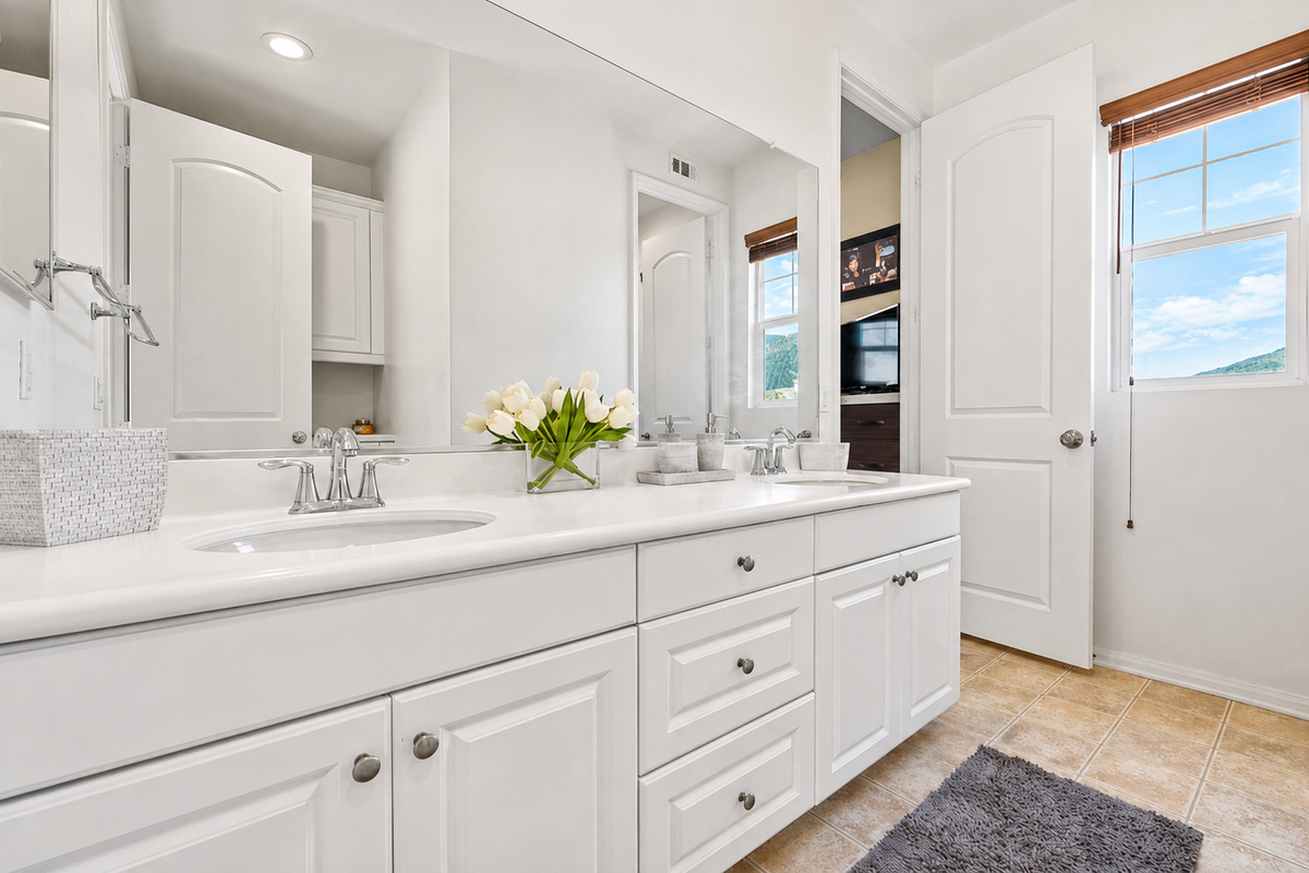 Primary bathroom vanity with double sinks, lots of counter space, and a clean setup for getting ready.