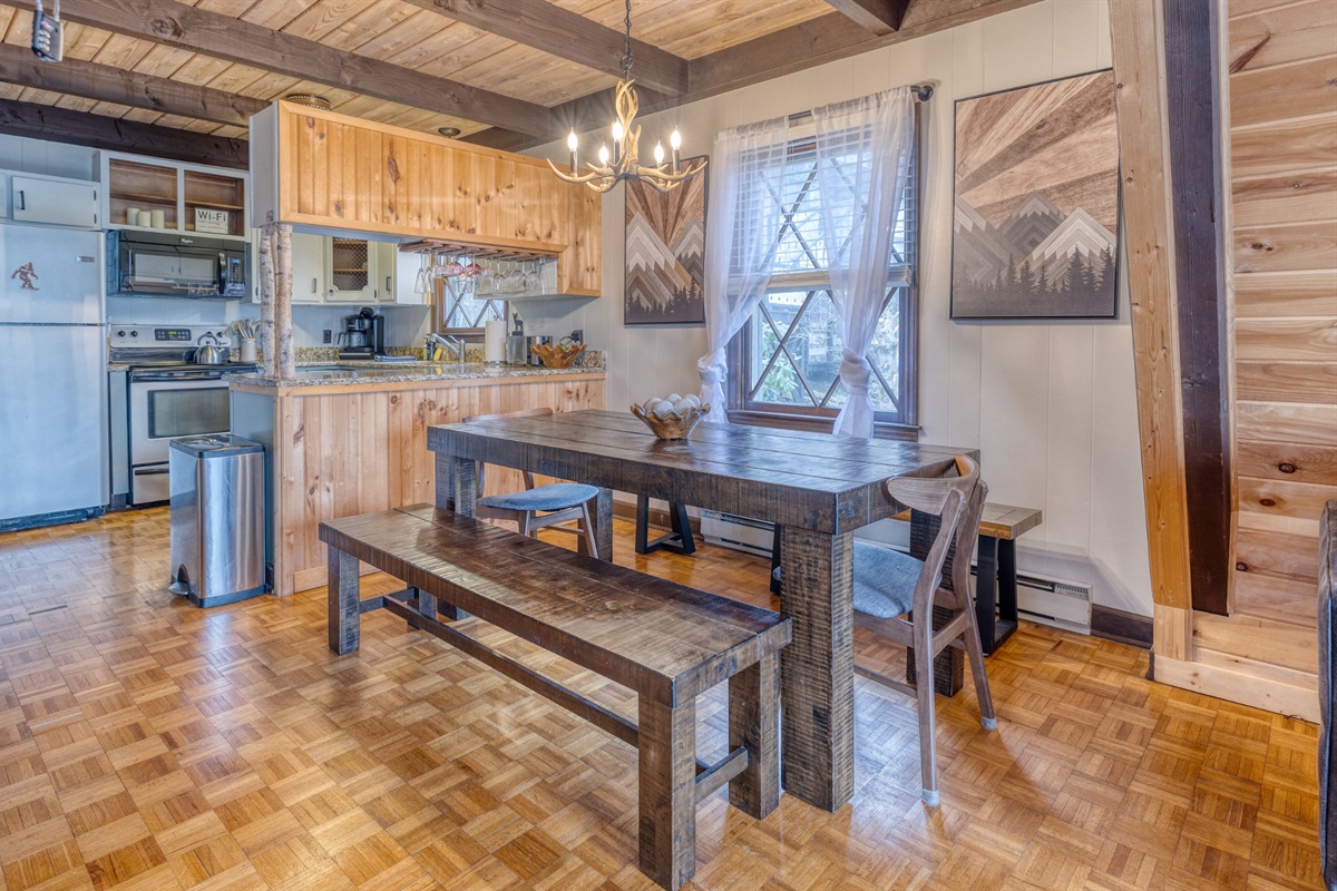The spacious dining area seats 12, perfect for family meals. Enjoy the warm ambiance and rustic charm, with easy kitchen access for meal prep.