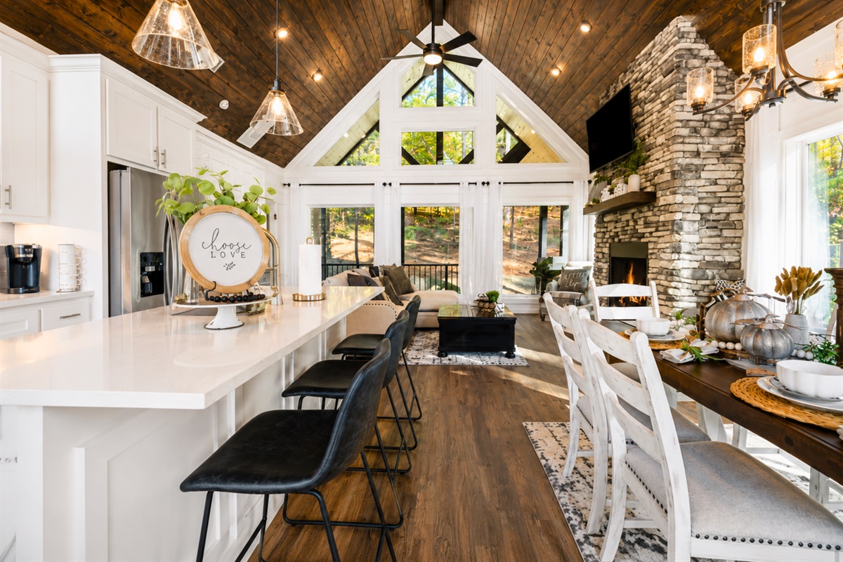 From the oversized windows to the rustic stone fireplace, every detail in this open-concept space was designed to feel warm, welcoming, and relaxing.