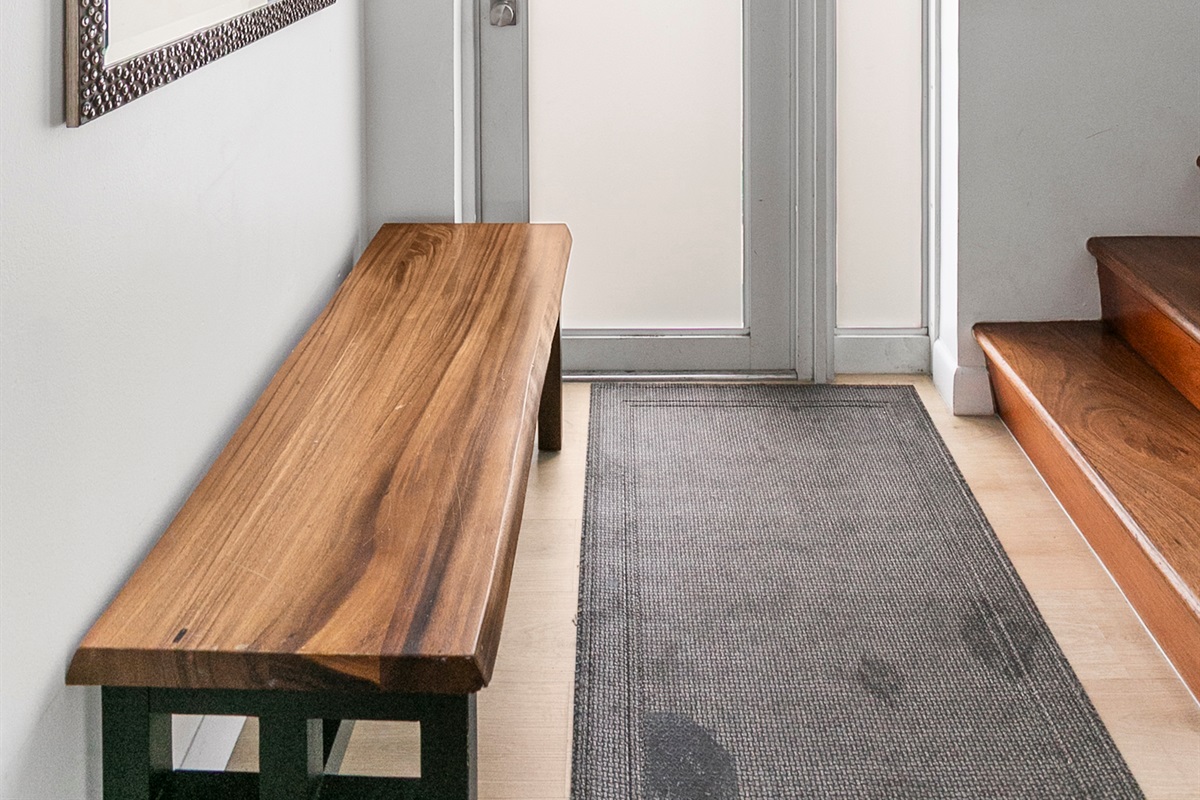 Private entrance foyer with storage space, easily accessible beach gear, and a bench