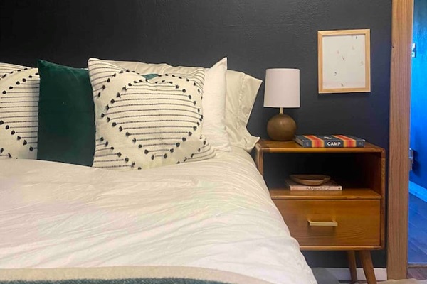 Downstairs Queen bed. With hanging rack and nightstand for your things. 