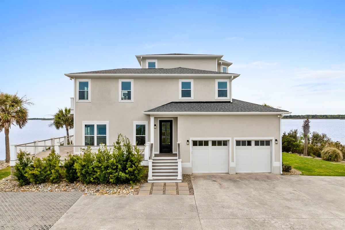 Stunning waterfront home exterior with spacious decks and premium outdoor living areas