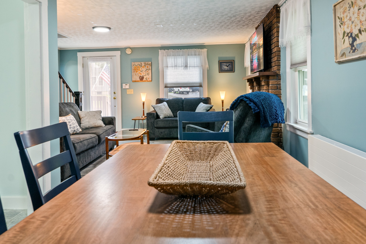 Transition seamlessly from dinner to relaxation. This open perspective connects the dining room right into the cozy living space, creating a large, unified gathering area where your group can watch a movie, stream a show, and unwind together.