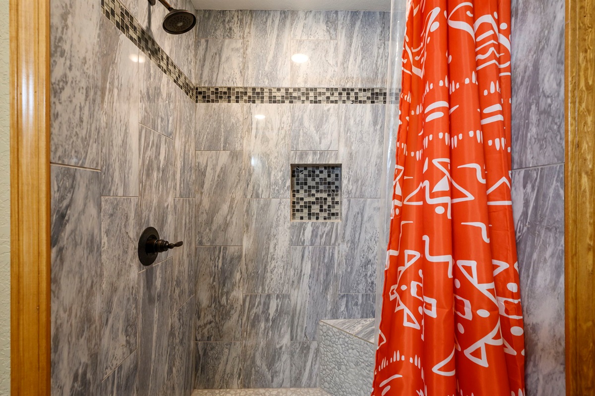 The bathroom has a nice sized shower, not a tub.