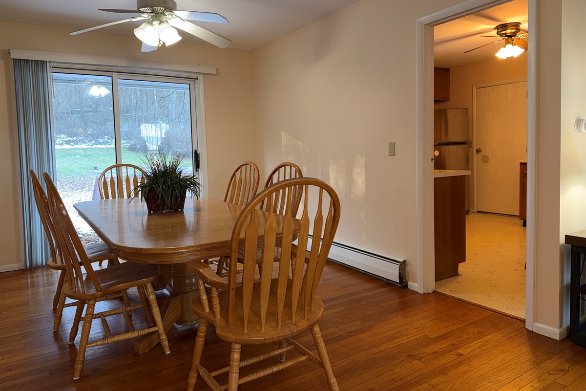 Dining table, sliding doors to back deck and kitchen