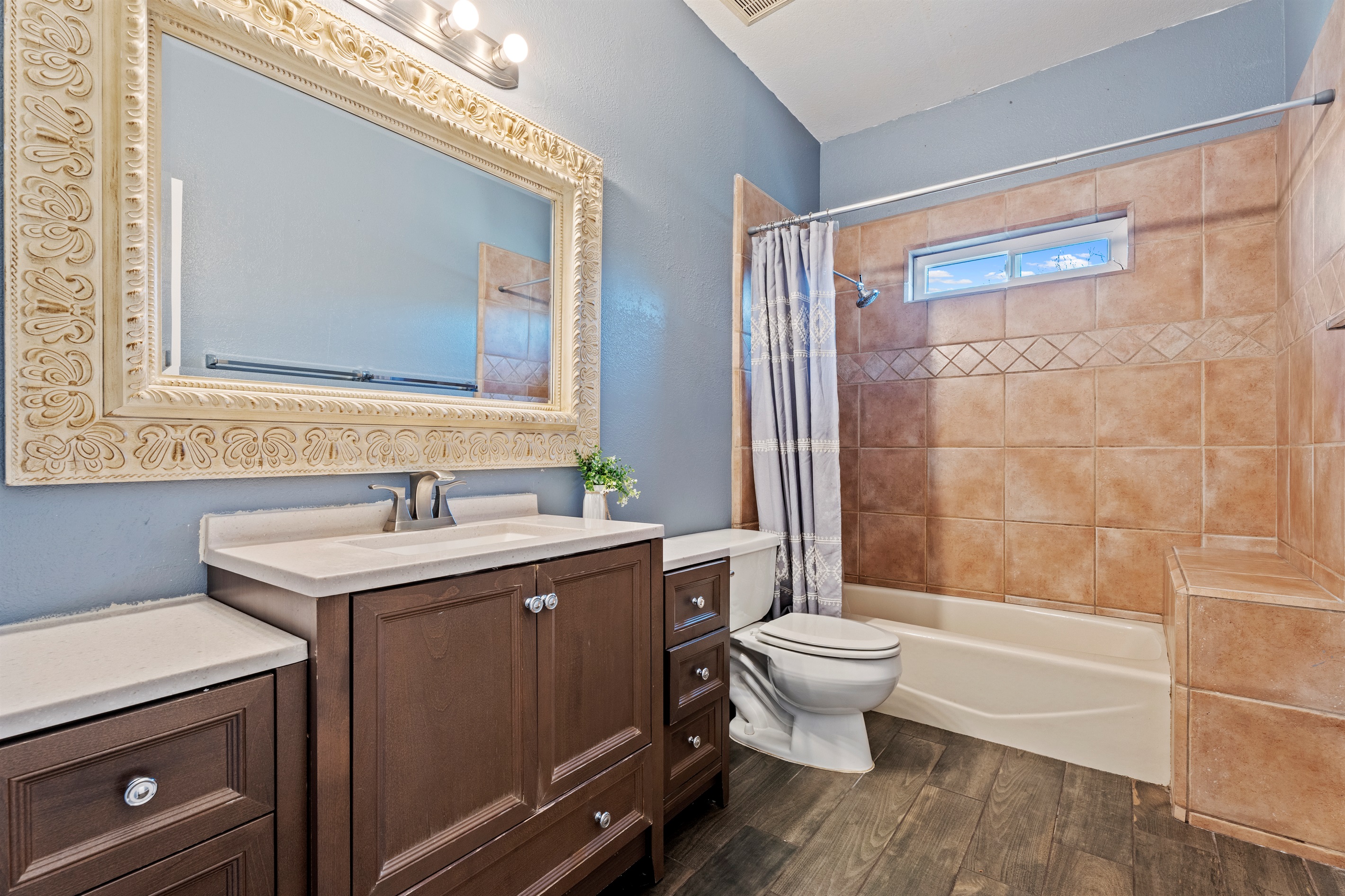 Relax and refresh in this stylish bathroom retreat featuring warm tile accents, a deep soaking tub, and spa-like vibes.