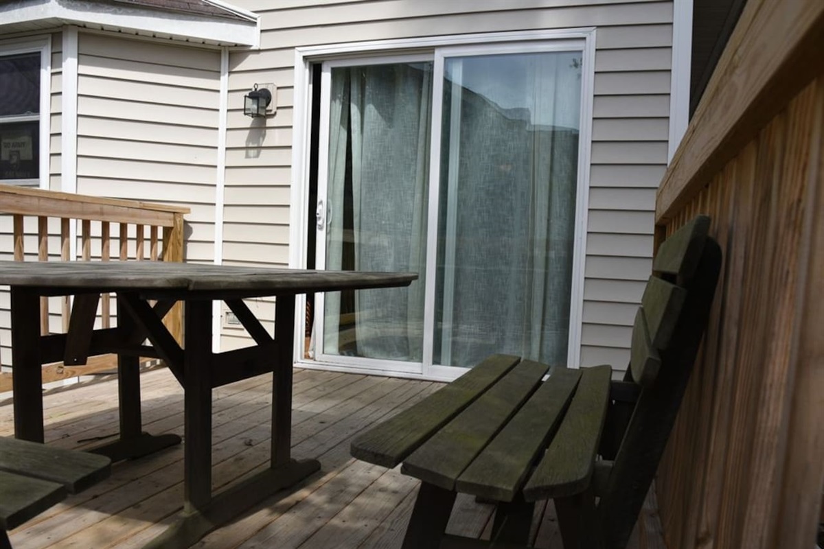 Outdoor deck in fenced in yard.