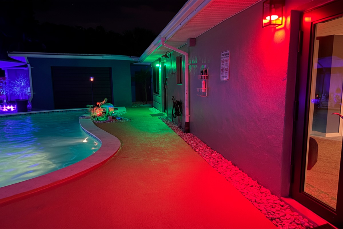 Evening poolside setting at Garden of Manors near The Red Room, enhanced by ambient lighting and tropical surroundings.