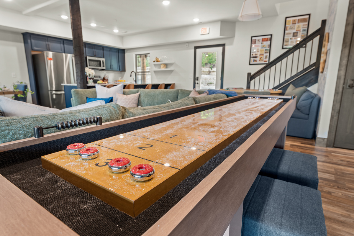 The shuffleboard table is waxed and the pucks are racked for a best-of-five in the game room.