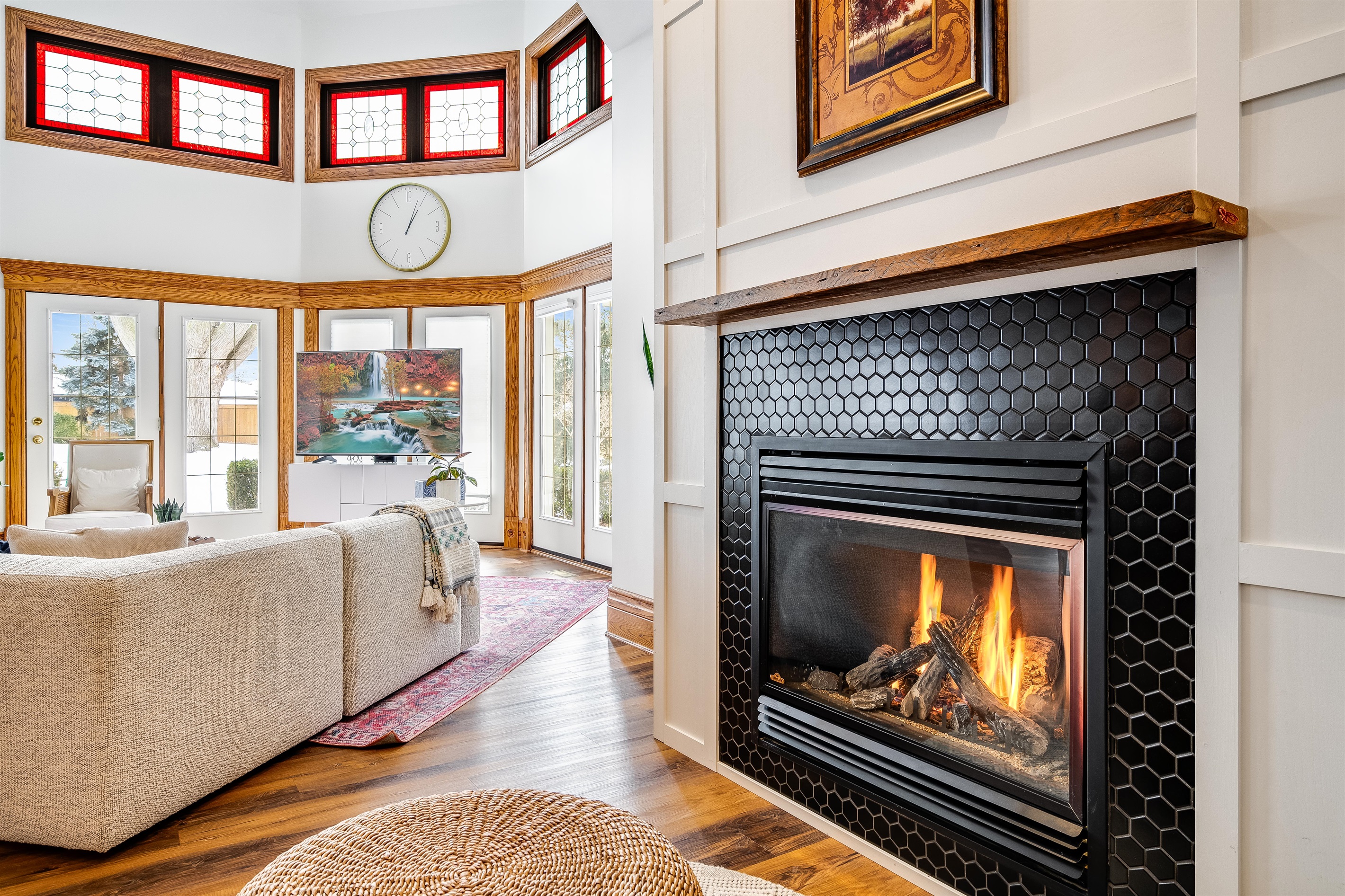 An open heart of the home, where chestnut warmth meets ivory walls and ruby-tinted sunlight flickers like firelight