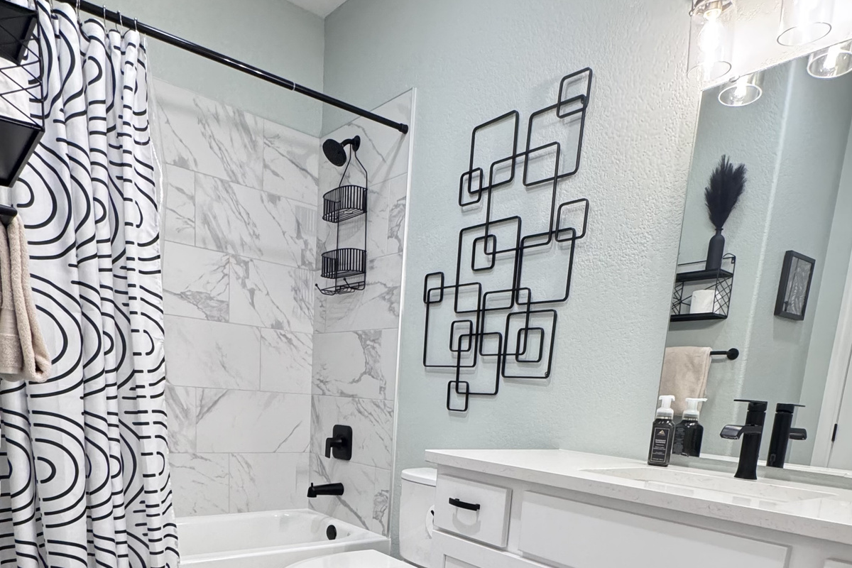 Shower-Tub combination with toilet, sink, towels, and toiletries. Bedroom 2 has private access or you may obtain access from the hallway.