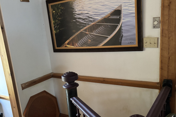 Upper end of spiral stairway from kitchen to lower level