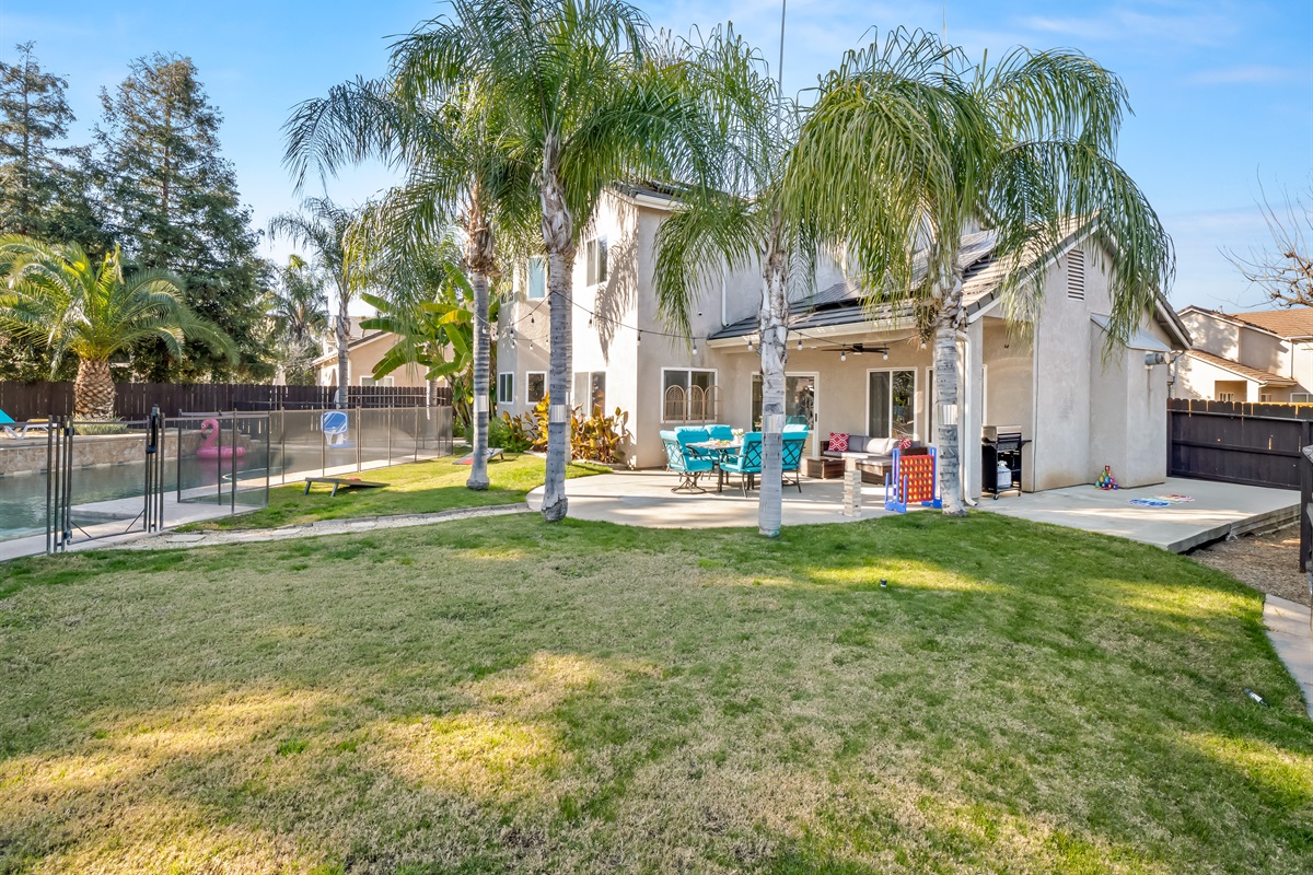 Large grassy lawn gives kids plenty of room to run, play games, and enjoy outdoor time safely.