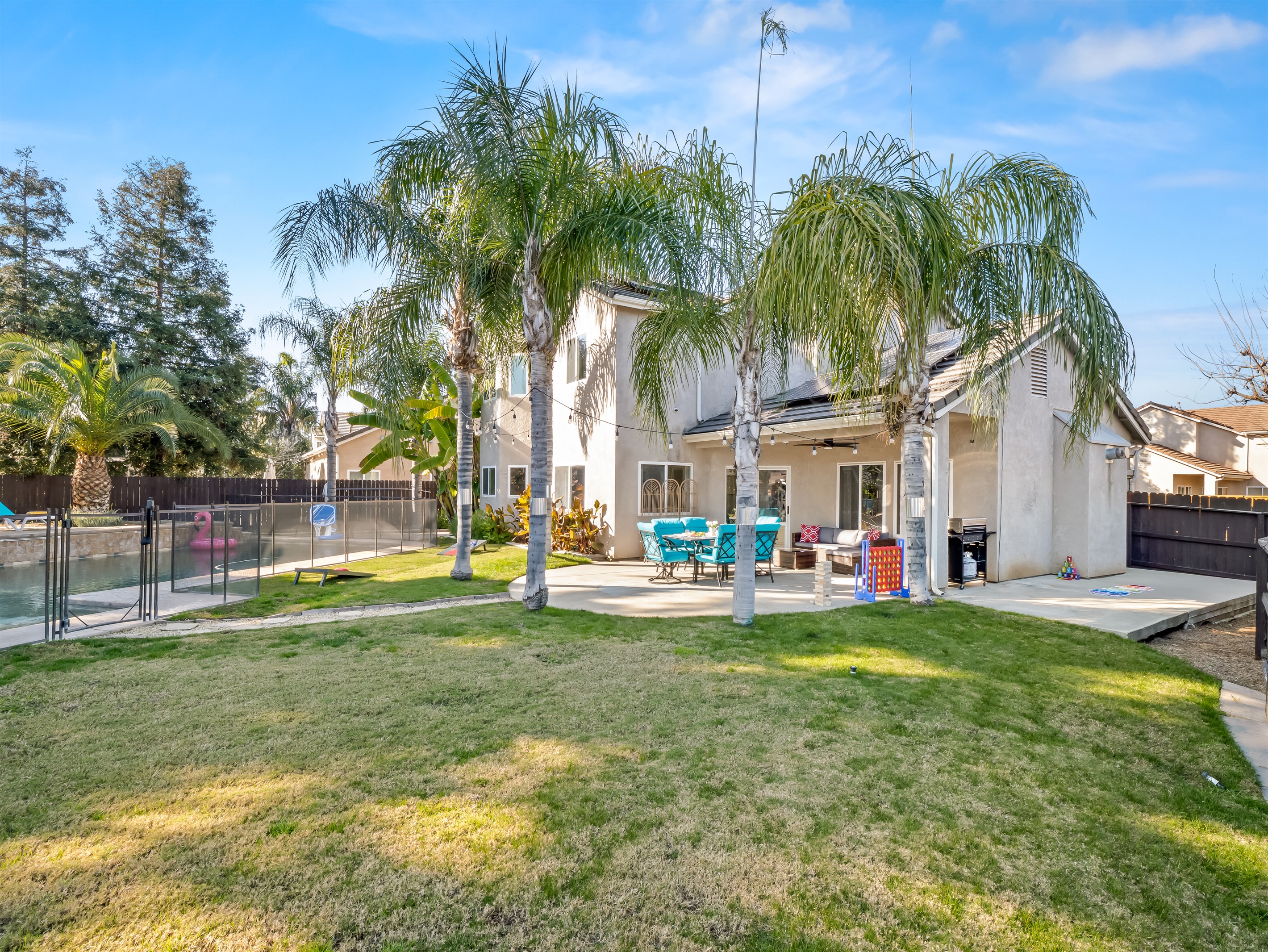 Large grassy lawn gives kids plenty of room to run, play games, and enjoy outdoor time safely.