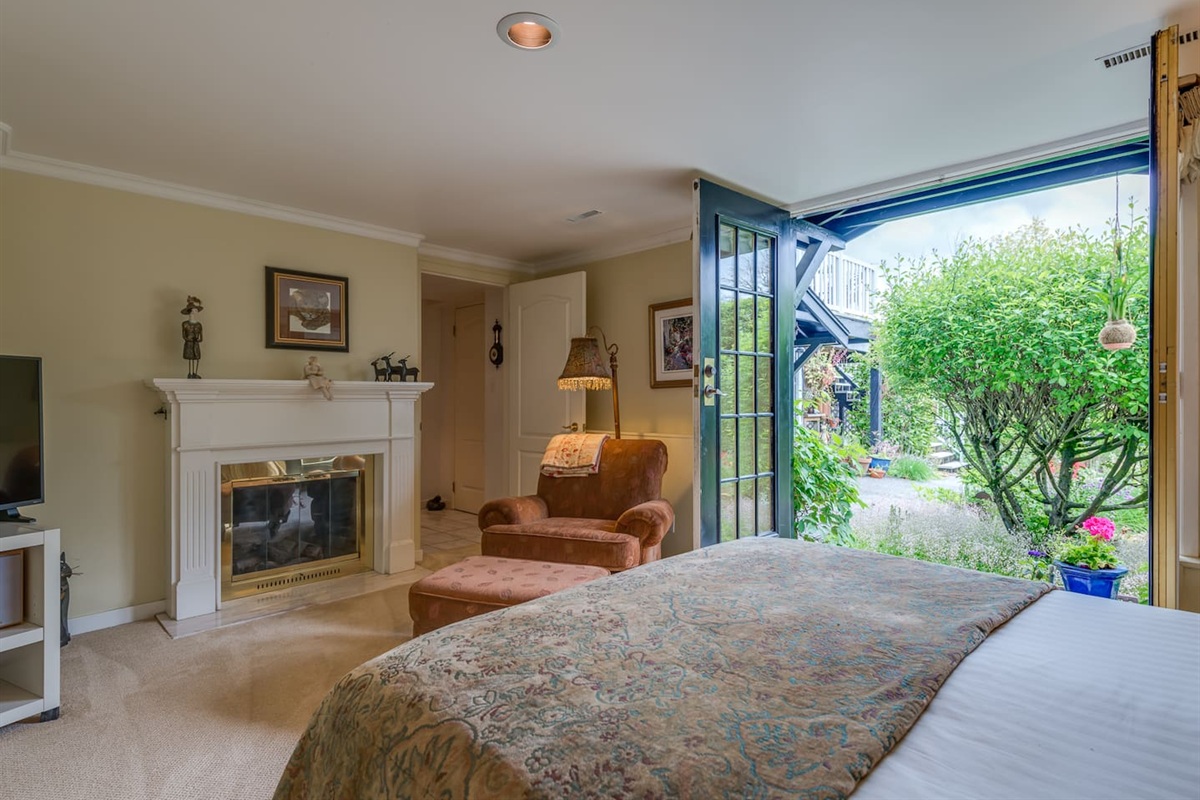 Double French doors leading to the garden and comfy reading chair and fireplace.