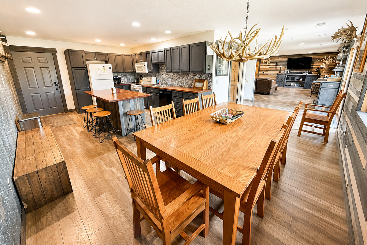 Large open kitchen and dining area designed for group stays, with generous seating and room for everyone to cook, eat, visit, and spend time together under one roof.