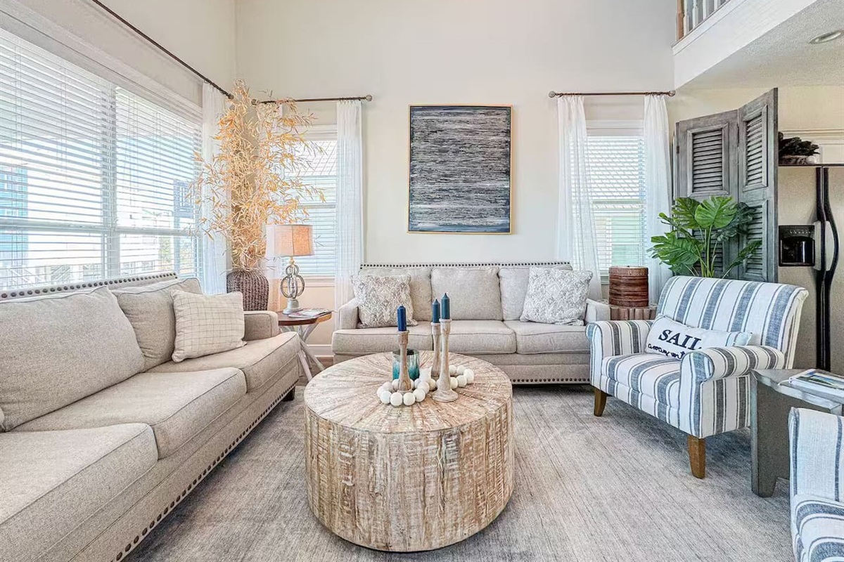 Beautifully designed living area with vaulted ceilings, coastal decor, and plenty of room to unwind in style.