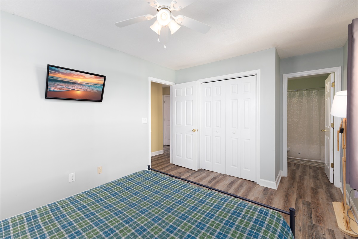 Queen-size bed in downstairs master bedroom