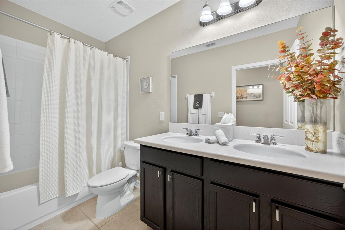 Clean and comfortable full bathroom with shower/tub combo.