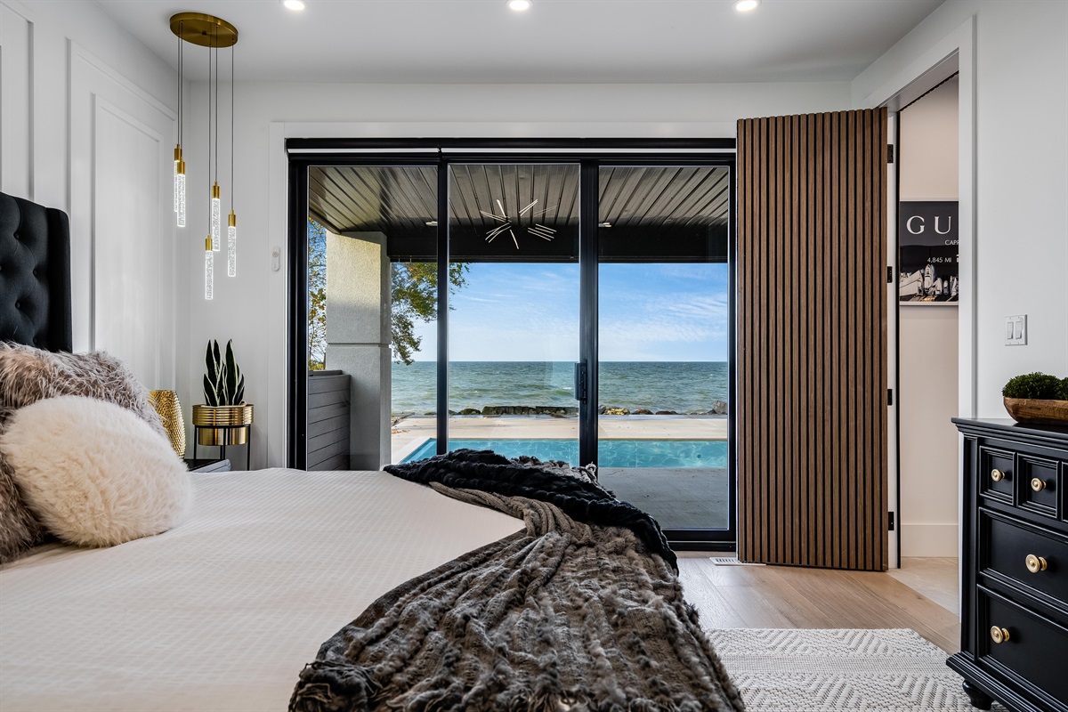 Main floor master bedroom with covered patio walk out and lake views.