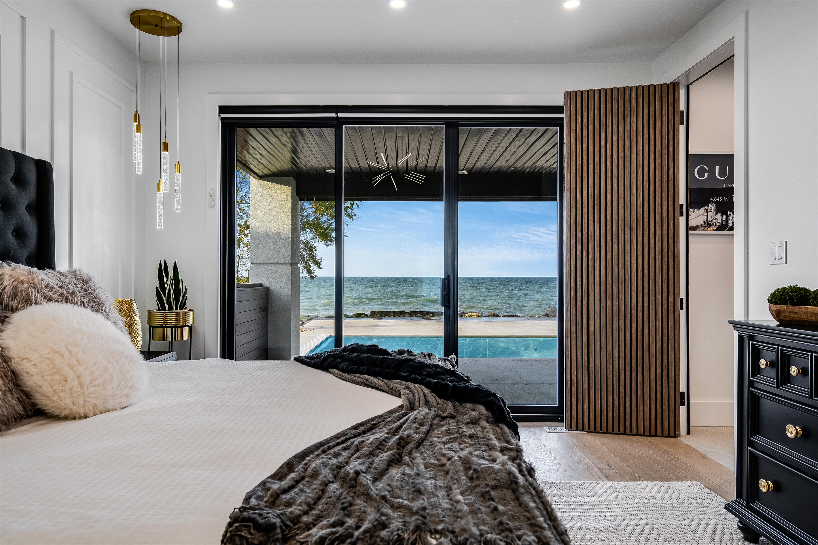 Main floor master bedroom with covered patio walk out and lake views.