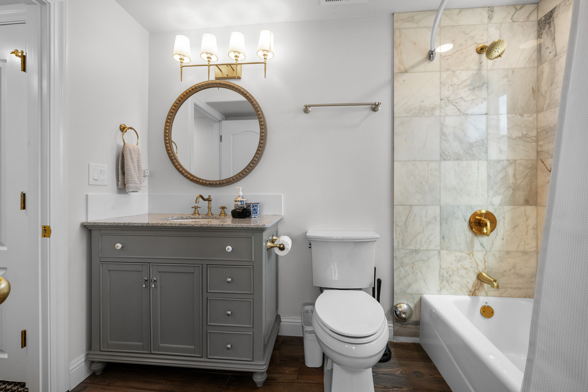  Elegant finishes, beautiful tile, and a graceful vanity create a polished bathroom designed for comfort and everyday convenience