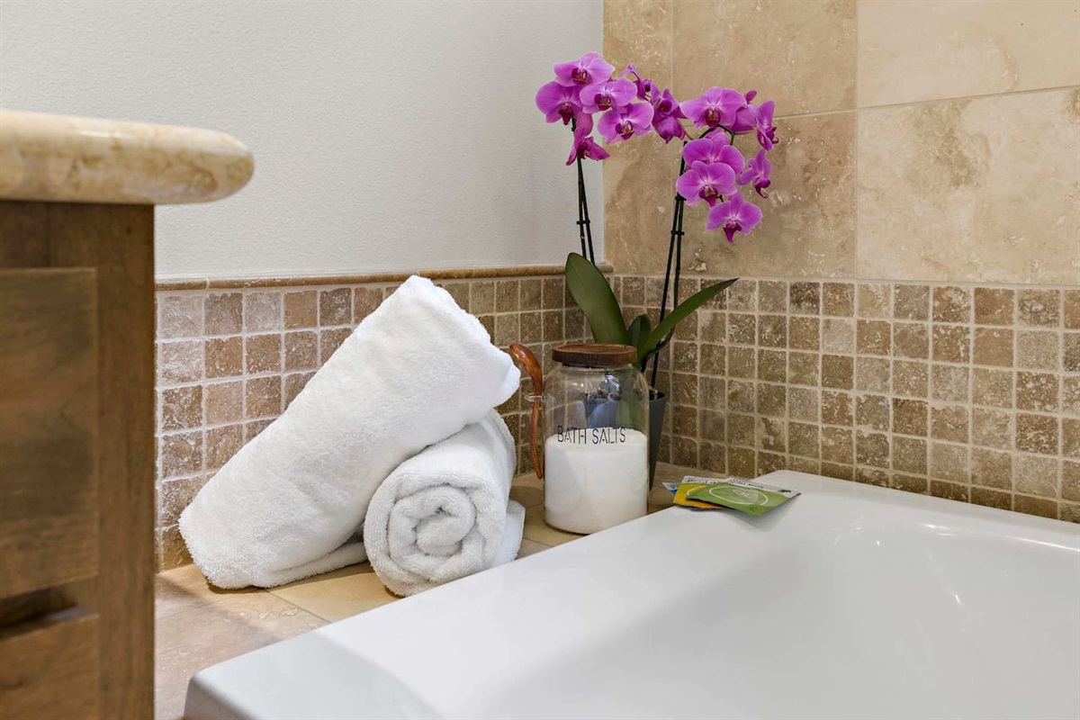 Escape with a warm bath with provided bath salts and relaxing spa music in the master bathroom.
