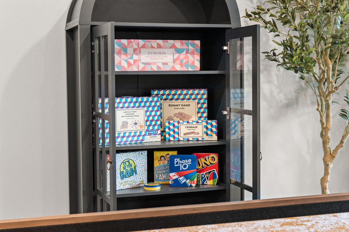 The game cabinet is stocked with Rummy, dominoes, Uno, and Phase 10 for rainy Ozark afternoons.