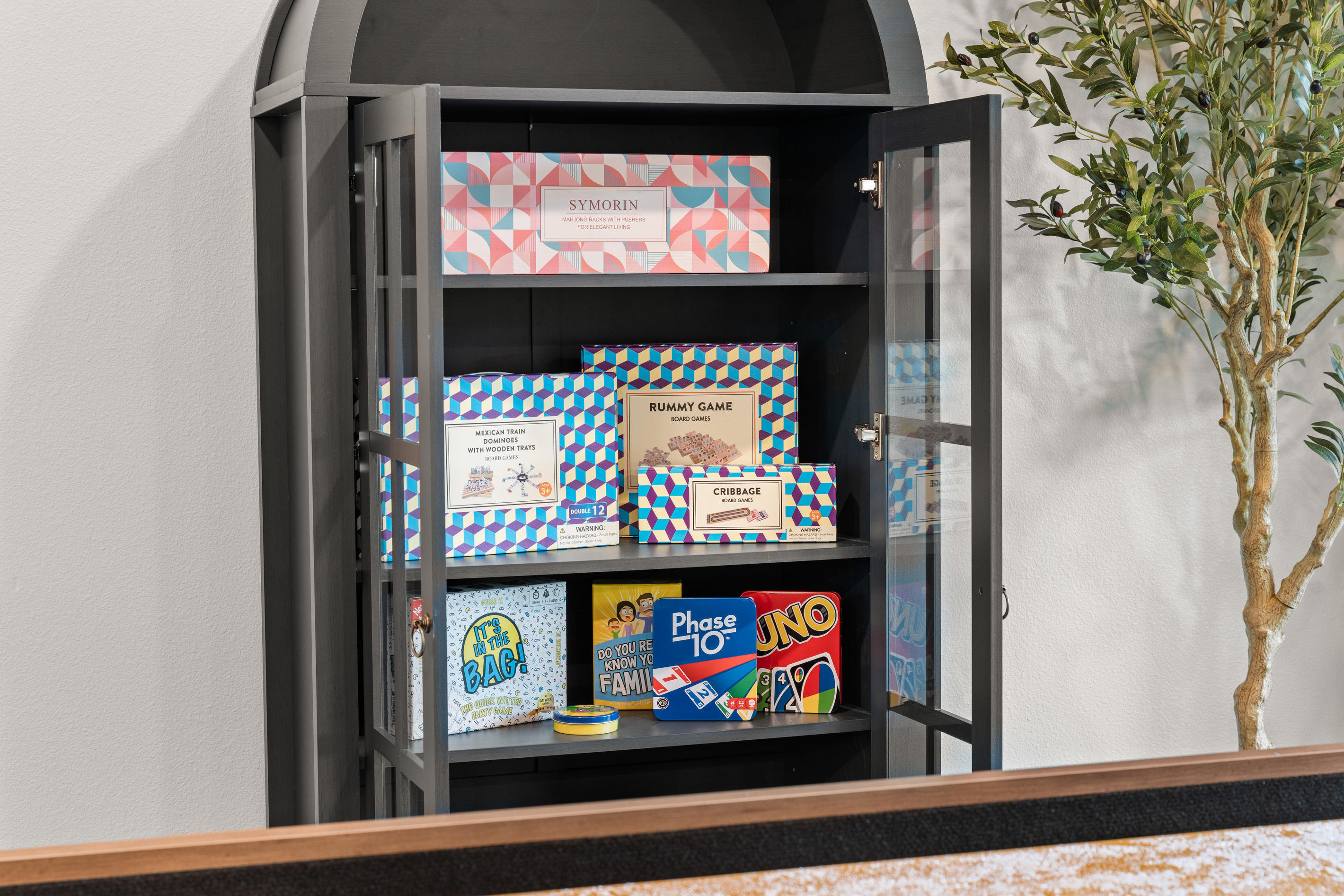 The game cabinet is stocked with Rummy, dominoes, Uno, and Phase 10 for rainy Ozark afternoons.