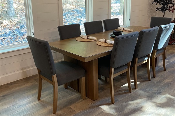 Dining table has eight chairs and an additional table leaf to extend 18"