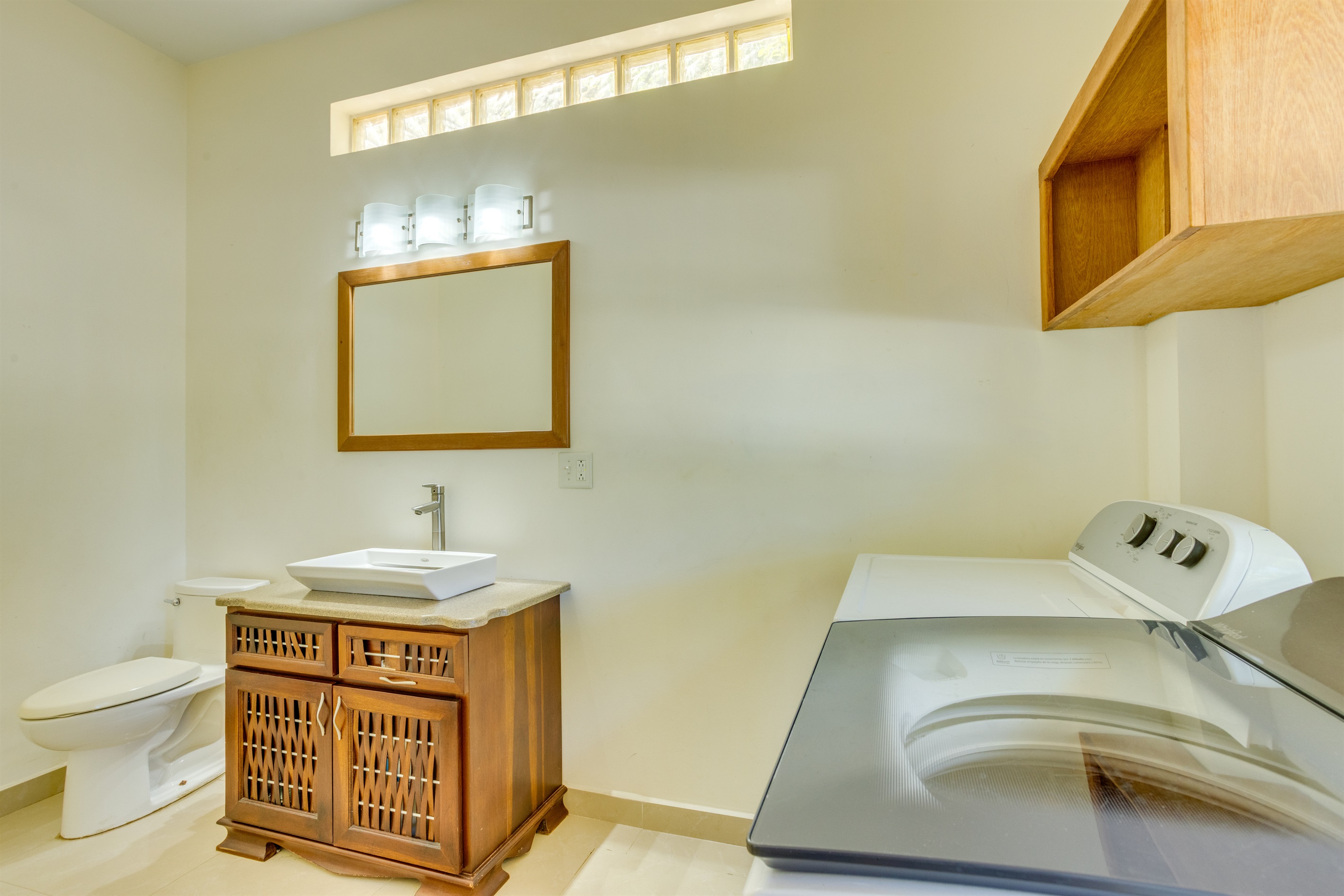 First floor half bathroom with laundry room